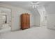 This bedroom has neutral carpeting, dormer windows, and a large wooden wardrobe at 205 Parliament Pl, Dunn, NC 28334