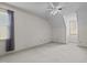 Large, empty bedroom with neutral carpeting, ceiling fan, and dormer window at 205 Parliament Pl, Dunn, NC 28334