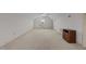 Bright bonus room with neutral carpet, ceiling fan, built-in shelves, and a large window at 205 Parliament Pl, Dunn, NC 28334