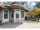 A view of the covered deck with large windows and a door, creating a comfortable outdoor space at 205 Parliament Pl, Dunn, NC 28334