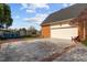 A view of the brick-lined driveway leading to a spacious garage with a well-maintained exterior at 205 Parliament Pl, Dunn, NC 28334