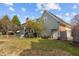 Exterior side view of the house showing a deck, garden area, and fenced-in yard at 205 Parliament Pl, Dunn, NC 28334