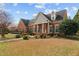 Traditional brick home with lush landscaping and a well-manicured lawn, showcasing its charm and elegance at 205 Parliament Pl, Dunn, NC 28334
