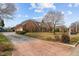 Spacious home features a circular driveway and a beautifully landscaped front yard at 205 Parliament Pl, Dunn, NC 28334