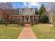 Inviting brick home with a red brick walkway and green shutters, enhancing its curb appeal at 205 Parliament Pl, Dunn, NC 28334