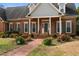 Attractive brick home with a neatly landscaped yard and brick pathway leading to the entrance at 205 Parliament Pl, Dunn, NC 28334