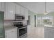 Modern kitchen featuring granite counters, stainless appliances, and a charming, sunlit breakfast area at 205 Parliament Pl, Dunn, NC 28334