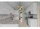Bright kitchen features white cabinetry, granite countertops, tiled floor, modern appliances, and natural light at 205 Parliament Pl, Dunn, NC 28334