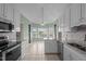 Bright kitchen features white cabinets, granite countertops, stainless appliances, and sunlit breakfast nook at 205 Parliament Pl, Dunn, NC 28334