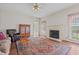 Bright living room with hardwood floors, fireplace, comfortable seating, and access to the breakfast nook at 205 Parliament Pl, Dunn, NC 28334