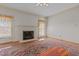 Cozy living room with a fireplace, hardwood floors, natural light, and a decorative rug at 205 Parliament Pl, Dunn, NC 28334