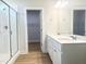 Elegant bathroom featuring a dual sink vanity, glass-enclosed shower, and modern fixtures at 207 Golfview Ave, Benson, NC 27504