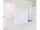 Carpeted bedroom with neutral walls features a walk-in closet for storage at 207 Golfview Ave, Benson, NC 27504