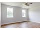 Spacious bedroom with ample natural light from two windows and modern ceiling fan at 207 Golfview Ave, Benson, NC 27504