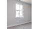 Bedroom with window view featuring neutral carpet and paint at 207 Golfview Ave, Benson, NC 27504