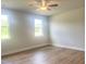 Spacious bedroom with hardwood floors, a ceiling fan, and windows, offering a comfortable retreat at 207 Golfview Ave, Benson, NC 27504