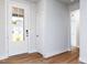 Bright entryway showcasing a white front door, wood-look floors, and neutral wall paint at 207 Golfview Ave, Benson, NC 27504
