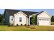 Side view of a single-story home featuring gray siding, white trim, and a well-maintained front lawn at 207 Golfview Ave, Benson, NC 27504
