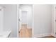 Bright hallway with wood floors and neutral paint leads to an additional room at 207 Golfview Ave, Benson, NC 27504