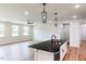 Open concept kitchen with a dark countertop, white cabinets, and bright recessed lighting at 207 Golfview Ave, Benson, NC 27504