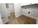 Practical laundry room with storage cabinets and washer/dryer hookups, offering convenience and efficiency at 207 Golfview Ave, Benson, NC 27504