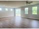 Open living room with hardwood floors, recessed lighting, and a sliding glass door to the outdoor patio at 207 Golfview Ave, Benson, NC 27504