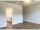 Comfortable main bedroom with a ceiling fan and a view of the ensuite bath at 207 Golfview Ave, Benson, NC 27504