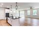Open-concept living area featuring kitchen island, stainless appliances, and access to outdoor patio at 207 Golfview Ave, Benson, NC 27504