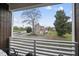 Balcony with a picturesque view of a neighboring home surrounded by lush trees and clear blue skies at 208 Martin Luther King Jr Blvd, Raleigh, NC 27601