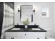 Modern bathroom with a double vanity, black countertop, and sleek fixtures at 208 Martin Luther King Jr Blvd, Raleigh, NC 27601
