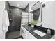Stylish bathroom featuring black marble tile, a double vanity, and updated fixtures at 208 Martin Luther King Jr Blvd, Raleigh, NC 27601