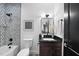 Modern bathroom with decorative tile, dark vanity, and updated fixtures at 208 Martin Luther King Jr Blvd, Raleigh, NC 27601