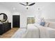 Bright bedroom features a ceiling fan, modern lighting, a dresser, and sliding glass doors at 208 Martin Luther King Jr Blvd, Raleigh, NC 27601