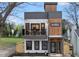 A modern multi-story condo features a light stone facade, wood accents, and black-trimmed windows and doors at 208 Martin Luther King Jr Blvd, Raleigh, NC 27601