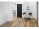 Hallway that features hardwood floors, a desk with gold accents, and black door with a white trim at 208 Martin Luther King Jr Blvd, Raleigh, NC 27601