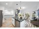 Open-concept living space with kitchen island, spiral staircase and sliding glass doors at 208 Martin Luther King Jr Blvd, Raleigh, NC 27601