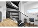 Modern interior view featuring a black spiral staircase and bright natural light through a window at 208 Martin Luther King Jr Blvd, Raleigh, NC 27601