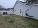Expansive backyard showing the house's exterior, a white fence, and a comfortable hammock chair at 225 Sebastian Way, Rocky Mount, NC 27804