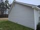 Side view of the house featuring light gray siding and well-kept greenery at 225 Sebastian Way, Rocky Mount, NC 27804