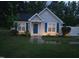 Charming single-story home with blue shutters and a well-manicured front yard with garden beds and walkway at 225 Sebastian Way, Rocky Mount, NC 27804
