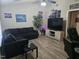 Spacious living room with a dark sofa, light wood floors, and large screen tv at 225 Sebastian Way, Rocky Mount, NC 27804