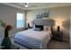 Cozy bedroom featuring a comfortable bed, bedside tables, and natural light from the window at 228 Pecan Valley Way, Four Oaks, NC 27524