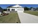 Charming two-story home with manicured lawn, gray stone accents, and a spacious two car garage at 228 Pecan Valley Way, Four Oaks, NC 27524