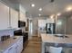 Stylish kitchen featuring modern stainless steel appliances, white cabinetry, and sleek countertops at 228 Pecan Valley Way, Four Oaks, NC 27524