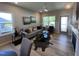 Bright and airy living room with modern decor, sleek flooring, and large windows for natural light at 228 Pecan Valley Way, Four Oaks, NC 27524