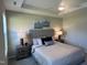 Comfortable main bedroom with a tray ceiling, plush bed, soft lighting, and elegant decor at 228 Pecan Valley Way, Four Oaks, NC 27524