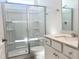Bright bathroom featuring a glass shower and a white vanity with a quartz countertop at 245 Golfview Ave, Benson, NC 27504
