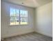 Bedroom with neutral carpet, white walls, and a bright window with a neighborhood view at 245 Golfview Ave, Benson, NC 27504
