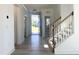 Entryway of home with a staircase, wood handrail and a view of the front door at 245 Golfview Ave, Benson, NC 27504