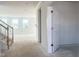 Bright entryway with white walls, staircase with wooden handrail, and multiple windows for natural light at 245 Golfview Ave, Benson, NC 27504